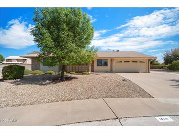 Charming single-story home with a well-maintained front yard and a two-car garage at 14215 N Boswell Blvd, Sun City, AZ 85351