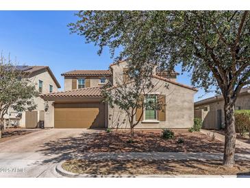 Charming two-story home featuring a stucco exterior, attached garage, and well-maintained landscaping at 20646 W Delaney Dr, Buckeye, AZ 85396