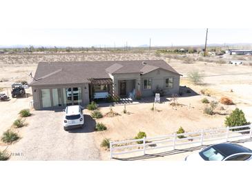 Charming single-story home with a cozy front porch and desert landscaping at 30439 W Peakview Rd, Wittmann, AZ 85361