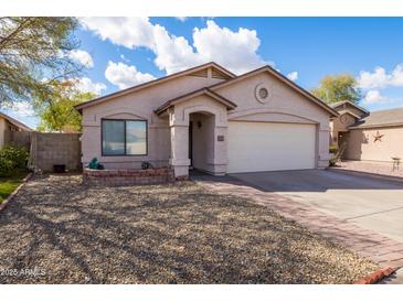 Charming single-story home with desert landscaping, attached garage, and inviting entryway at 3151 W Donald Dr, Phoenix, AZ 85027