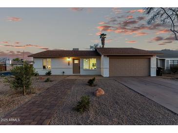 Charming single-story home with a brick pathway and well-maintained desert landscaping at 331 W Stanford Ave, Gilbert, AZ 85233