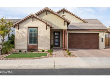 Charming single-story home featuring a brick driveway, two car garage and welcoming front entryway at 6926 W Spur Dr, Peoria, AZ 85383