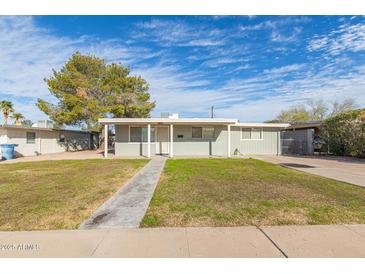 Charming single-story home featuring a well-maintained front yard and a covered entry at 800 W 12Th St, Tempe, AZ 85281