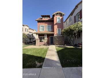 Charming two-story home with a well-manicured lawn and inviting front porch at 1304 S Owl Dr, Gilbert, AZ 85296