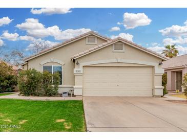 Charming single-story home with well-maintained lawn and neutral-toned exterior at 2083 E Saratoga St, Gilbert, AZ 85296