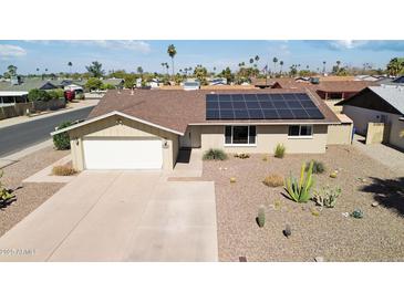 Well-maintained home with a two-car garage, desert landscaping, and solar panels at 3640 W Redfield Rd, Phoenix, AZ 85053