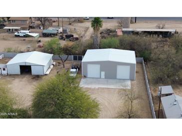 Wide aerial view of outbuildings and yard at 4311 W Siesta Way, Laveen, AZ 85339