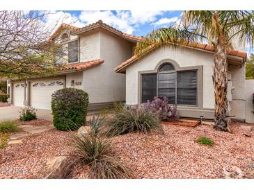 Charming home exterior with well-maintained desert landscaping, including cacti and stone accents at 4558 E Vista Dr, Phoenix, AZ 85032
