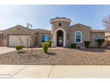 Charming home featuring a decorative front door and turret detail, complemented by low-maintenance desert landscaping at 4884 S Hemet St, Gilbert, AZ 85298