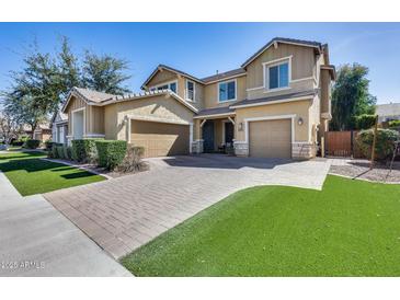 Beautiful two-story home featuring a three-car garage and a well-manicured front yard at 7363 E Plata Ave, Mesa, AZ 85212