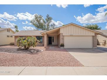 Charming single-story home featuring a two-car garage, manicured front yard, and appealing curb appeal at 10903 E Sahuaro Dr, Scottsdale, AZ 85259