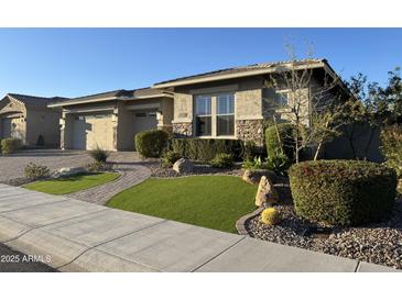 Charming single-story home with manicured lawn and stone accents at 11612 W Candelilla Way, Peoria, AZ 85383