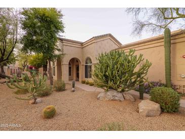 Charming home featuring desert landscaping, including saguaro and barrel cactus and decorative rock at 18932 N 89Th Way, Scottsdale, AZ 85255