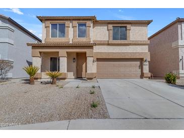 Charming two-story home with tan stucco, well-kept landscaping and a two car garage in a well-maintained neighborhood at 28793 N Spur Dr, San Tan Valley, AZ 85143