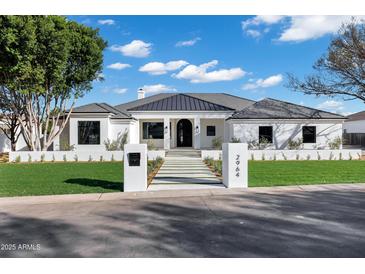 Stunning exterior showcasing a modern white home with a well-manicured lawn and paved walkway to the front door at 2964 E Palo Verde St, Gilbert, AZ 85296