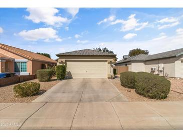 Charming single-story home featuring a well-maintained front yard and a two-car garage at 3018 W Matthew Dr, Phoenix, AZ 85027