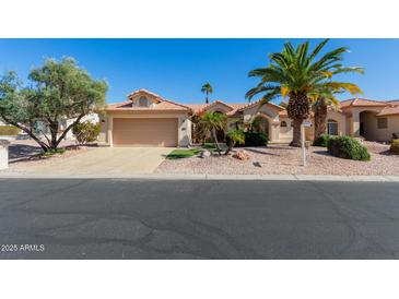 Charming single-story home featuring desert landscaping, a barrel tile roof, and a two-car garage at 3191 N 160Th Ave, Goodyear, AZ 85395