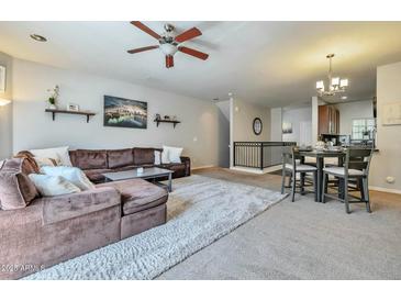 Spacious living room features a cozy sectional sofa, ceiling fan, and an open layout at 3434 E Avalon Dr, Phoenix, AZ 85018