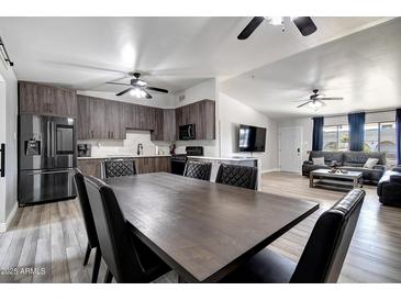 Open layout showcases the modern kitchen connected to the dining area and living room at 4026 N 81St St, Scottsdale, AZ 85251