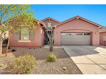 Charming single-story home featuring a stucco facade, desert landscaping, and an attached two-car garage at 4027 E Mark Ln, Cave Creek, AZ 85331