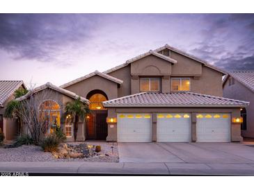 Charming two-story home featuring a three-car garage, desert landscaping, and well-lit exterior at 5381 W Del Rio St, Chandler, AZ 85226