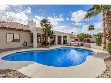 Backyard featuring a private pool, covered patio, and lush landscaping at 6118 E Star Valley St, Mesa, AZ 85215