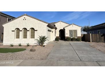 Charming single-story home featuring desert landscaping and a spacious driveway at 6915 S Sapphire Way, Chandler, AZ 85249