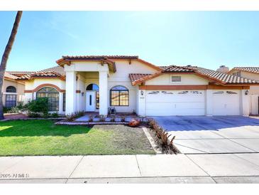 Inviting single-Gathering home with a well-manicured lawn and a three car garage at 819 W Harbor Dr, Gilbert, AZ 85233