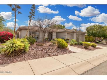 Beautiful single-story home with desert landscaping, including colorful plants and gravel accents at 11133 N 120Th Pl, Scottsdale, AZ 85259