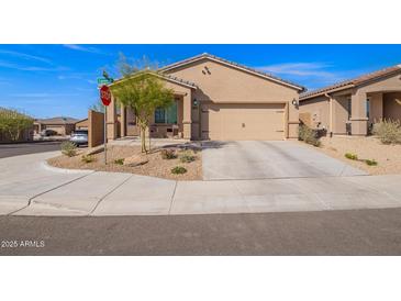 Charming single-story home featuring a two-car garage, neutral stucco exterior, and low-maintenance desert landscaping at 11458 W Camden Dr, Youngtown, AZ 85363