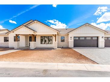 Charming single-Gathering home featuring a neutral color palette, desert landscaping, and a two-car garage at 1645 E Minton St, Mesa, AZ 85203