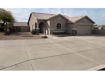 Charming single-story home with a well-manicured yard and a spacious driveway at 24638 N 65Th Ave, Glendale, AZ 85310