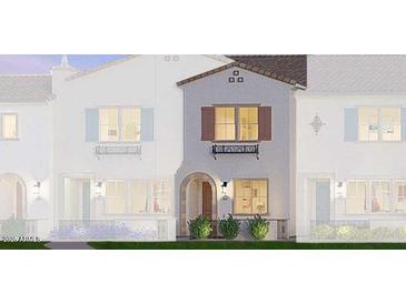 Charming townhome featuring a white stucco facade, arched entryway, and decorative window shutters at 2658 S Sulley Dr # 105, Gilbert, AZ 85295