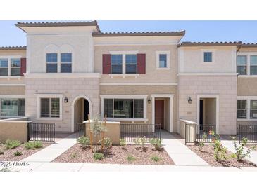 Inviting townhome featuring desert landscaping, neutral tones and symmetrical design at 2663 S Equestrian Dr # 106, Gilbert, AZ 85295