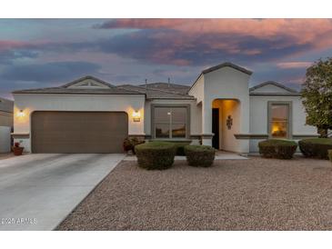 Charming single-story home featuring a well-manicured yard, neutral stucco, and inviting front entrance at 36070 N Quiros Dr, San Tan Valley, AZ 85143