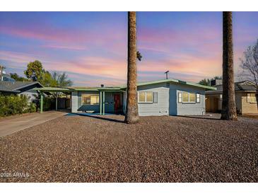 Charming single-story home with desert landscaping and covered parking at 406 W Flower St, Phoenix, AZ 85013