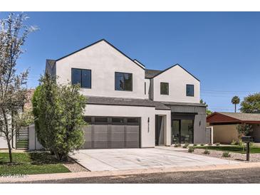 Contemporary home boasts clean lines, a spacious driveway, and low-maintenance landscaping at 4640 E Glenrosa Ave, Phoenix, AZ 85018