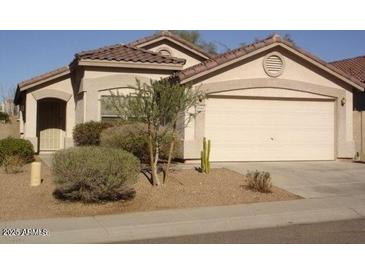 Single level home with a beige stucco finish, desert landscaping, and a two car garage at 5050 E Roy Rogers Rd, Cave Creek, AZ 85331