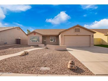 Charming single-story home with a neutral color palette, well-maintained landscaping, and a two car garage at 8947 W Sierra Vista Dr, Glendale, AZ 85305