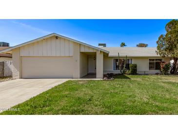 Charming single-story home with a well-manicured lawn and attached two-car garage at 14426 N 52Nd Ave, Glendale, AZ 85306