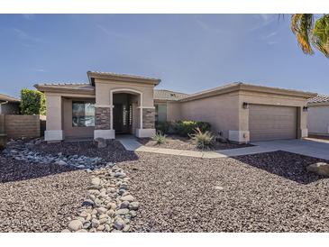 Charming single-story home with desert landscaping and neutral color palette at 14837 W Crocus Dr, Surprise, AZ 85379