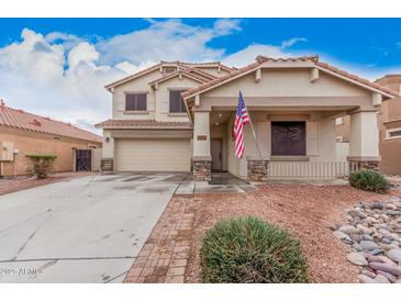 Charming two-story home with a two-car garage and a welcoming front porch, complemented by a well-maintained yard at 21 W Red Mesa Trl, San Tan Valley, AZ 85143