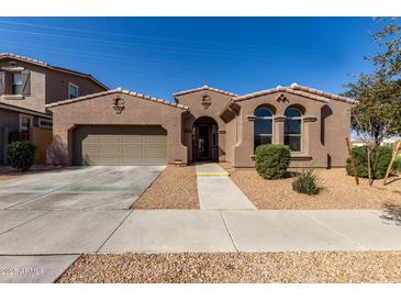 Charming single-story home featuring a well-maintained front yard and a two-car garage at 22624 S 224Th Pl, Queen Creek, AZ 85142