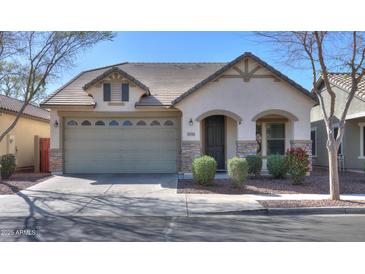 Charming single-story home featuring a two car garage, neutral stucco, and decorative stone accents at 4135 E Cathy Dr, Gilbert, AZ 85296