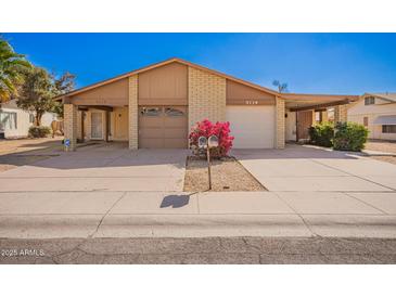 Charming home featuring a spacious driveway, two-car garage, desert landscaping, and well-maintained front yard at 5115 W Surrey Ave, Glendale, AZ 85304