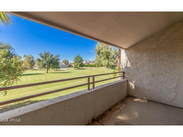 View from balcony features lush green landscaping and blue sky at 7350 N Via Paseo Del Sur -- # O212, Scottsdale, AZ 85258