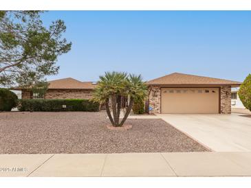 Charming single-story home featuring low-maintenance landscaping and a two-car garage at 9946 W Willow Creek Cir, Sun City, AZ 85373