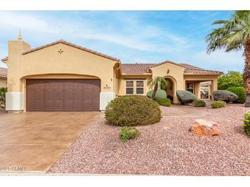 Charming single-story home featuring a well-manicured front yard, desert landscaping, and a two-car garage at 12852 W El Sueno Dr, Sun City West, AZ 85375