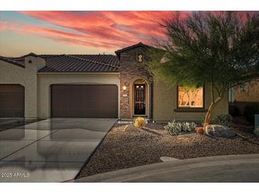 Charming single-story home featuring stone accents, desert landscaping, and a two-car garage at 16945 W Vernon Ave, Goodyear, AZ 85395