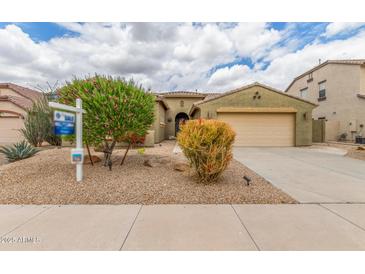 Charming single-story home with a two-car garage, desert landscaping, and mature trees in a desirable neighborhood at 18178 W Desert View Ln, Goodyear, AZ 85338